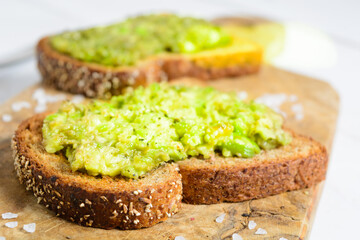 Healthy avocado toast with spices on whole wheat bread