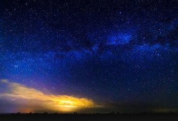 Milky way and starry sky. Bright cloud in the background.