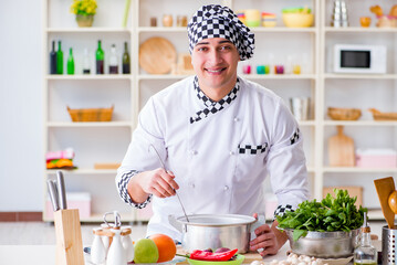 Young male cook working in the kitchen