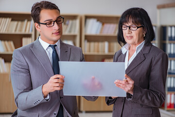 Businesspeople discussing business results on tablet computer