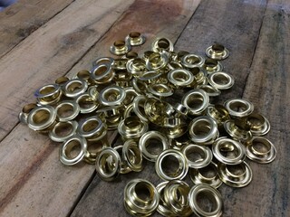 Gold Eyelet Ring on Wood Table
