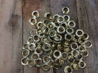 Gold Eyelet Ring on Wood Table