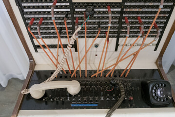 Old telephone exchange with lines and earphone.