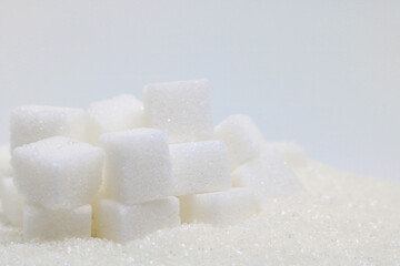 Pure refined sugar and sugar cubes. Sweet food ingredient, the diet health risks related to diabetes and calorie intake.