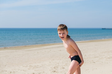 Fototapeta na wymiar Playful kids on summer beach sand vacation having fun and happy time