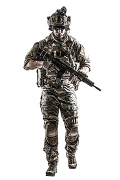 US Army rangers in combat uniforms with his shirt sleeves rolled up, in helmet, eyewear and night vision goggles moving walking towards camera. Studio shot, white background, dark contrast