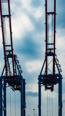 Fototapeta na wymiar Crane Construction against blue sky background. Steel industry crane at sea port, image for transportation, heavy industry construction concept