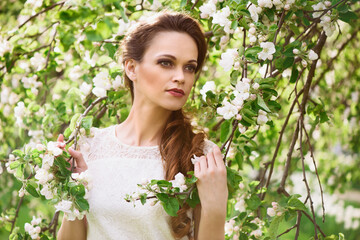 beautiful woman near the blossoming spring tree