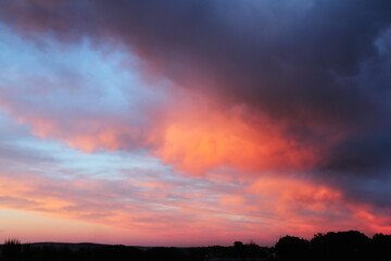 Beautiful sunset with pink and orange clouds. Evening sky background.