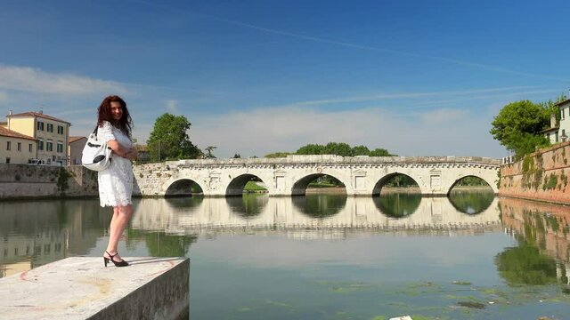 mature woman near ancient bridge in Europe