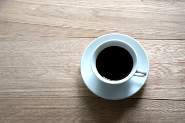 Coffee cup top view on wooden table background
