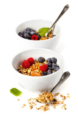 Granola with fresh organic raspberries and blueberries. Healthy breakfast