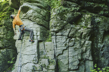 A young man climbs in a canyon.