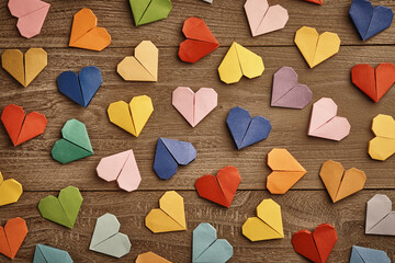 Colorful Handmade origami hearts background on table