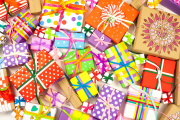 Fototapeta na wymiar Colored gift boxes with colorful ribbons. Yellow background. Gifts for Christmas or a birthday.