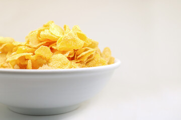 Cornflake cereals in a white bowl. Easy breakfast for kids. Quick breakfast.