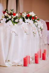 Newlyweds table decorated with bouquet and candles