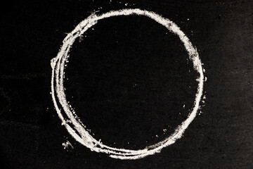 Chalk drawing as circle shape as blank stamp or seal on blackboard background