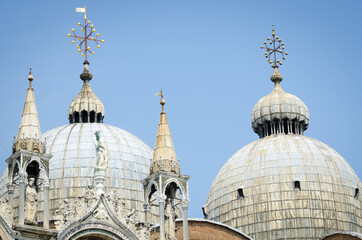 Fototapeta na wymiar Detail close-up of the intricate Byzantine domed architecture of St Mark's Basilica in Venice, Italy