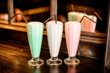 Three different colored milkshakes
