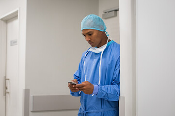 Young doctor using phone