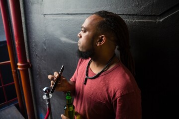 Man smoking electronic cigarette at the entrance