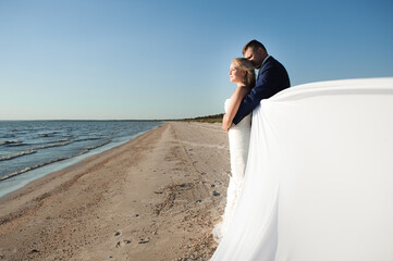 Bride and groom by the sea on their wedding day