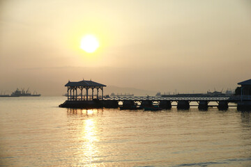 Fototapeta na wymiar Stock Photo - wooded bridge in the port along sunrise.
