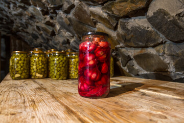 Preservation, pickles, marinades, in glass jars stand in the basement