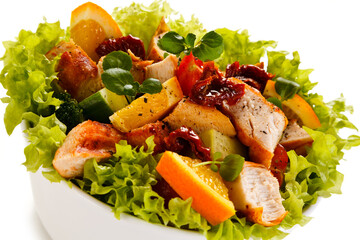 Salad with grilled chicken on white background