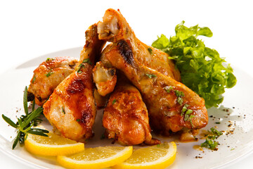 Roast chicken drumsticks on white background