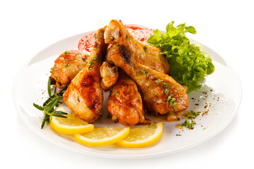 Roast chicken drumsticks on white background