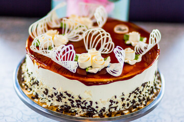 Chocolate cake watered flowers stands on a table