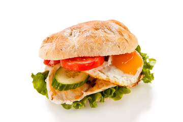 Sandwich with fried egg and chicken fillet on white background