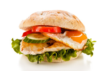 Sandwich with fried egg and chicken fillet on white background