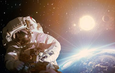 Astronaut in outer space against the backdrop of the planet earth. Elements of this image furnished...