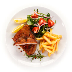 Roast steak with french fries on white background