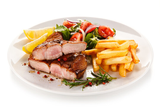 Roast steak with french fries on white background