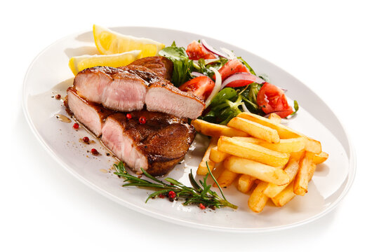 Roast steak with french fries on white background