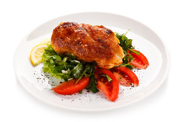 Grilled chicken fillet with vegetables on white background