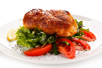 Grilled chicken fillet with vegetables on white background