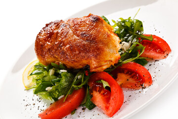 Grilled chicken fillet with vegetables on white background