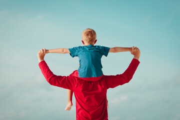 happy father and son playing on sky