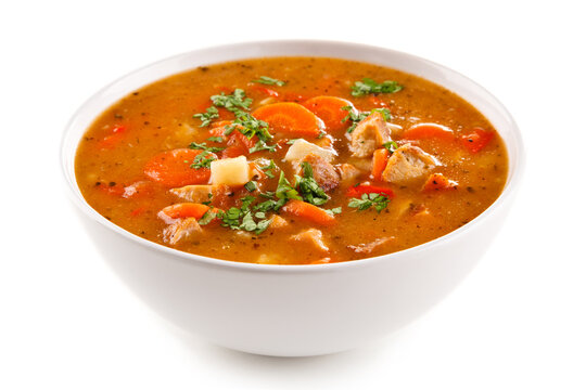 Tomato soup with carrot and chicken on white background