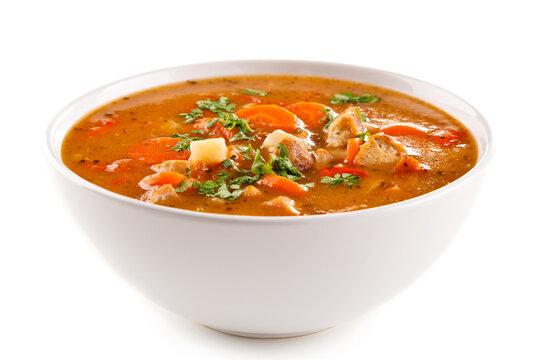 Tomato soup with carrot and chicken on white background