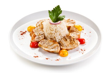 Grilled chicken with rice and vegetables on white background