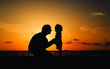 Fototapeta na wymiar father and daughter talking on sunset beach