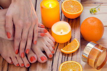 orange manicure around oranges and candles