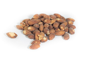 Salted and roasted almonds on white background