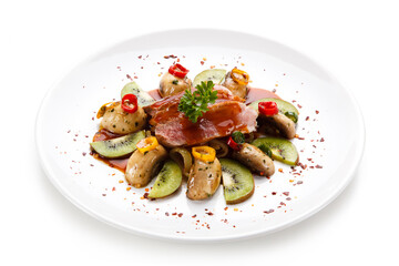 Carpaccio steak with vegetables and kiwi on white background